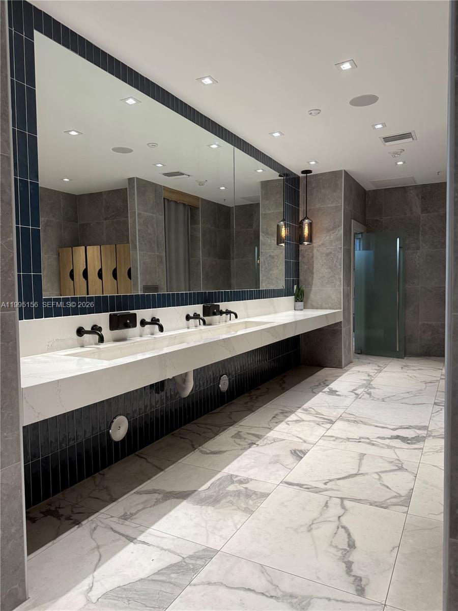 90 Southwest 3rd Street, Unit 2112 Miami, FL 33130 - Photo 28 of 40 a bathroom with a sink double vanity and a shower