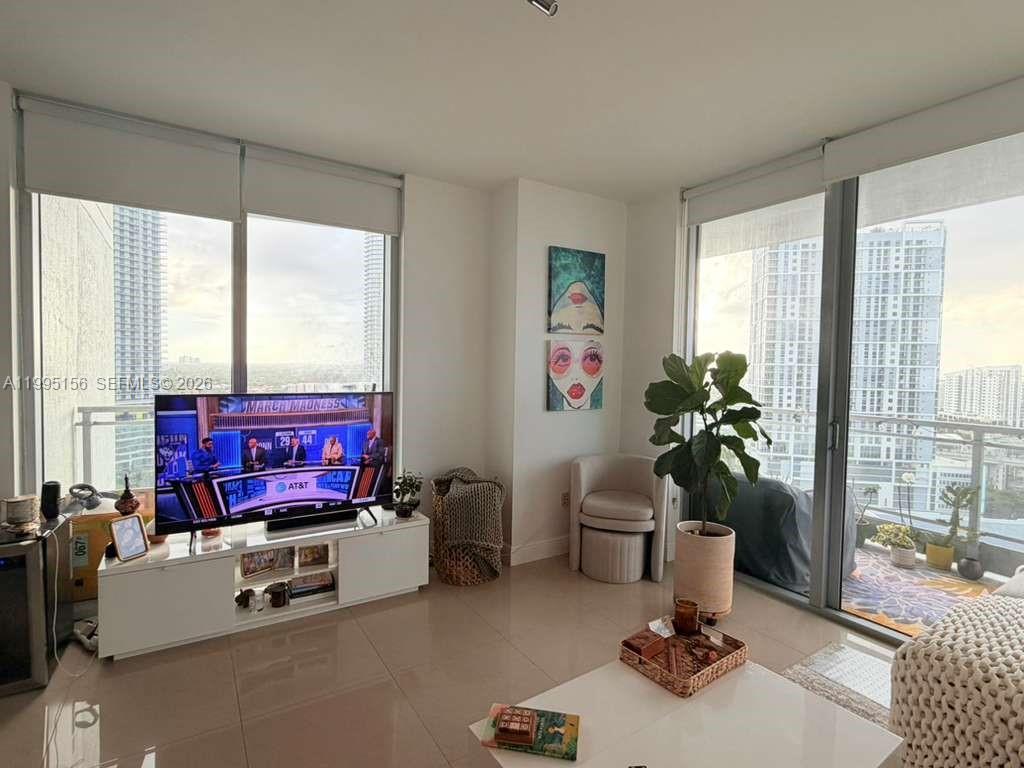 90 Southwest 3rd Street, Unit 2112 Miami, FL 33130 - Photo 6 of 40 a living room with furniture and a floor to ceiling window