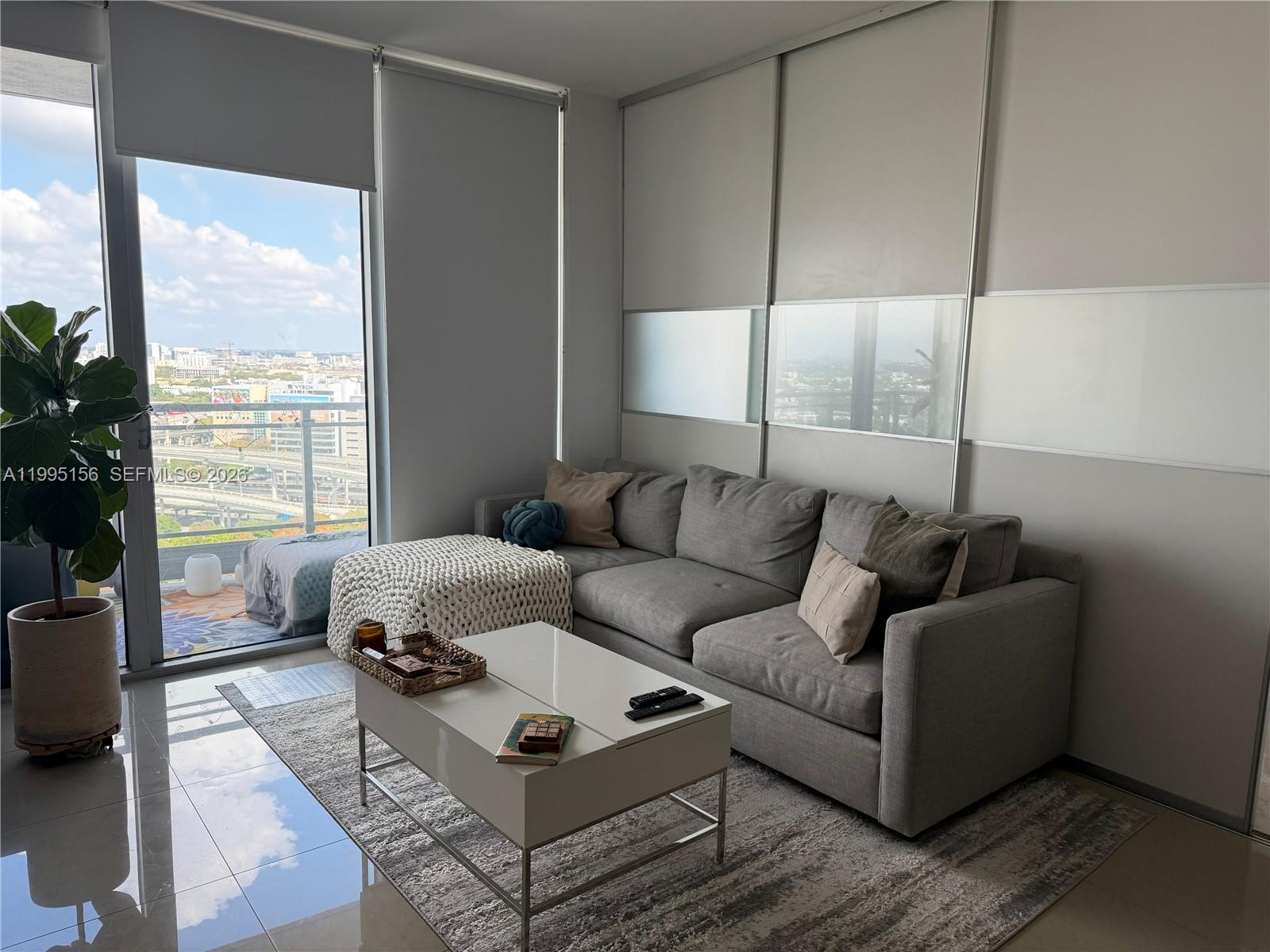 90 Southwest 3rd Street, Unit 2112 Miami, FL 33130 - Photo 9 of 40 a living room with furniture and a large window