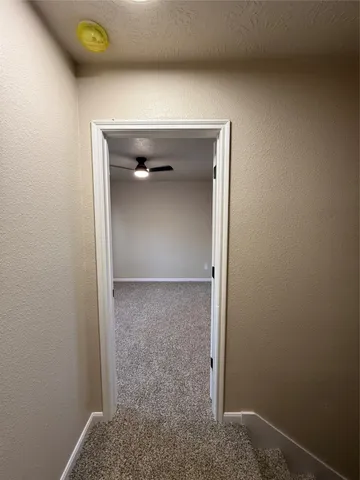 a view of hallway with wooden floor