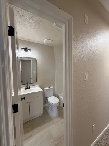 a bathroom with a toilet and a bath tub