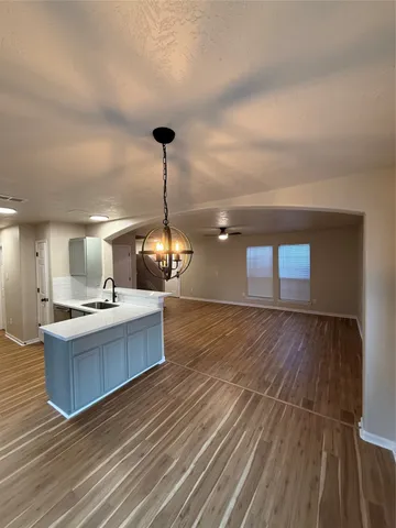 a view of kitchen and living room with wooden floor