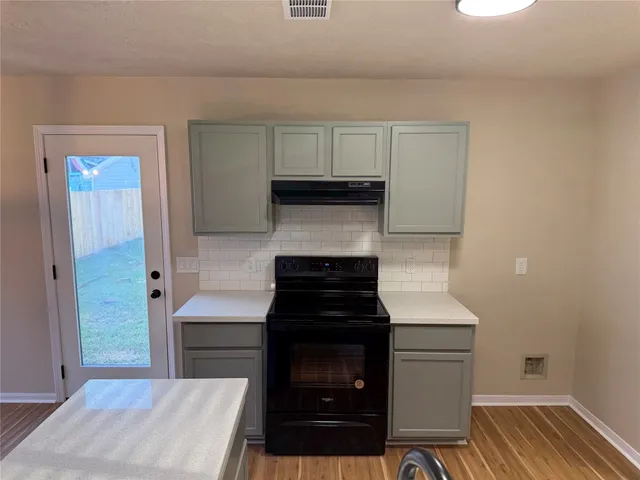 a kitchen with a stove and a cabinet