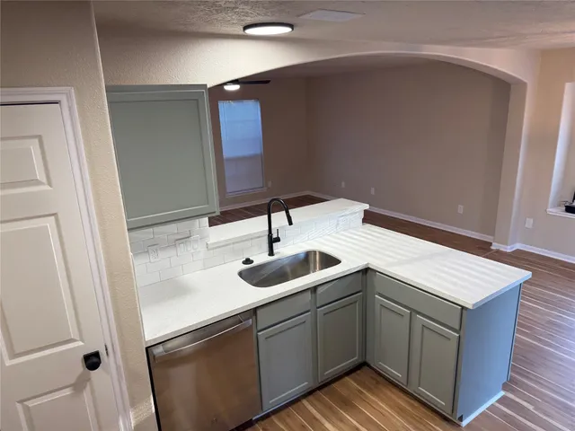 a kitchen with a sink and a mirror