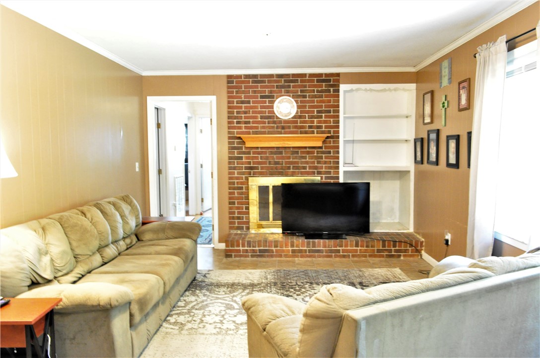 418 Ponce DeLeon Drive Anderson, SC 29621 - Photo 4 of 17 Living room with gas fireplace and built in book c