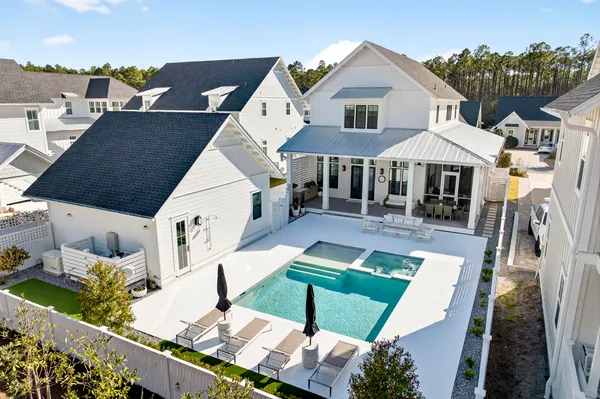 a view of a house with swimming pool and sitting area
