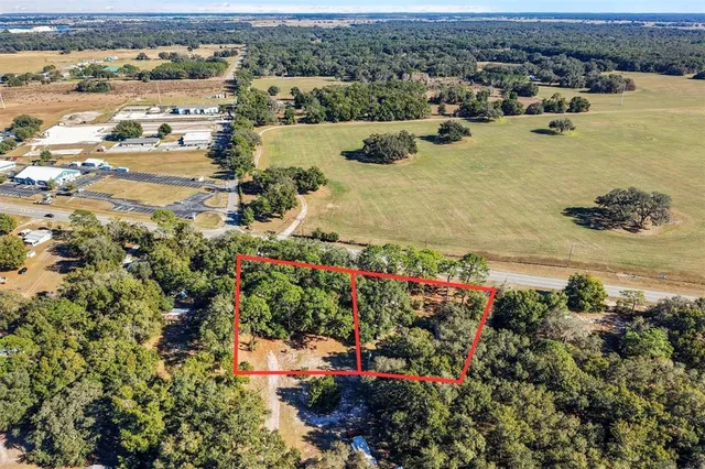 an aerial view of a houses with a lake view