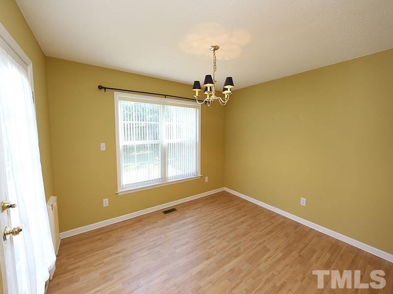 4405 Moss Spring Drive Raleigh, NC 27616 - Photo 3 of 12 a view of an empty room with a window and wooden floor