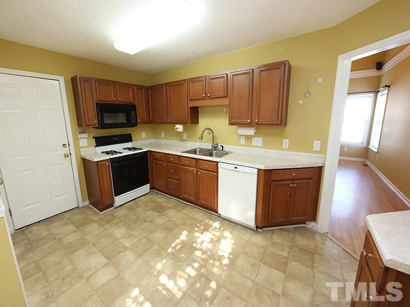 4405 Moss Spring Drive Raleigh, NC 27616 - Photo 4 of 12 a kitchen with stainless steel appliances granite countertop a stove sink and microwave