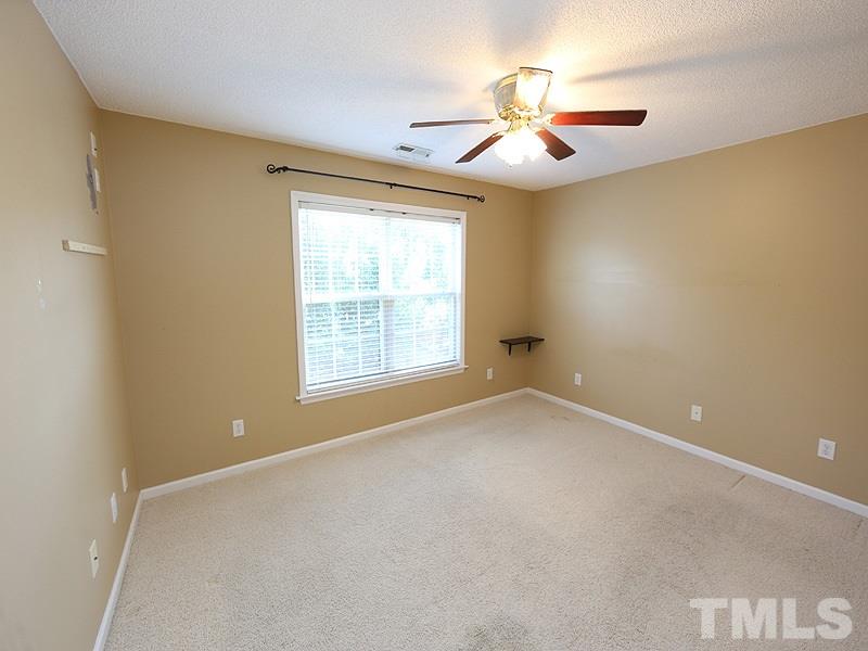 4405 Moss Spring Drive Raleigh, NC 27616 - Photo 7 of 12 an empty room with windows and fan