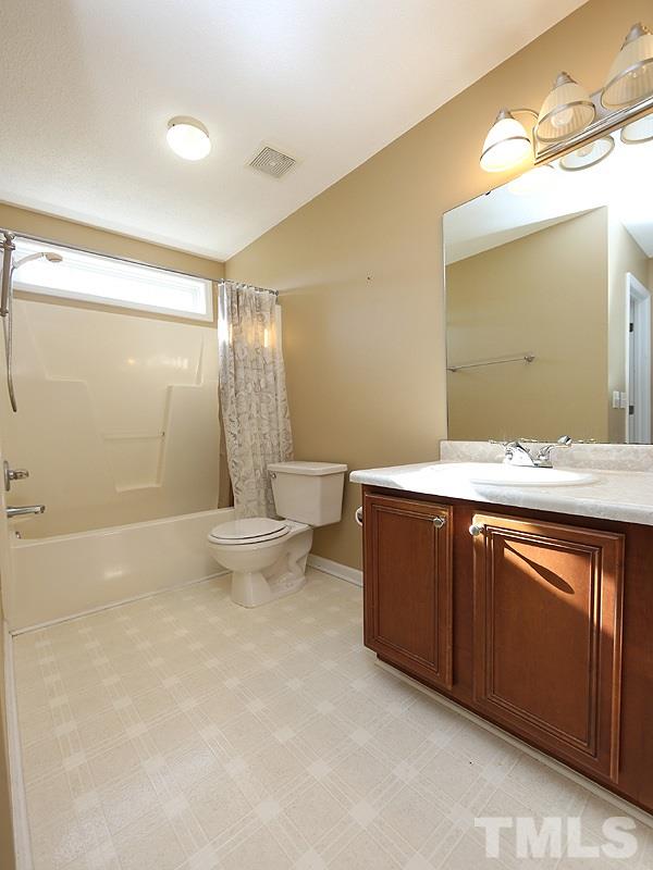 4405 Moss Spring Drive Raleigh, NC 27616 - Photo 8 of 12 a bathroom with a sink mirror and a toilet