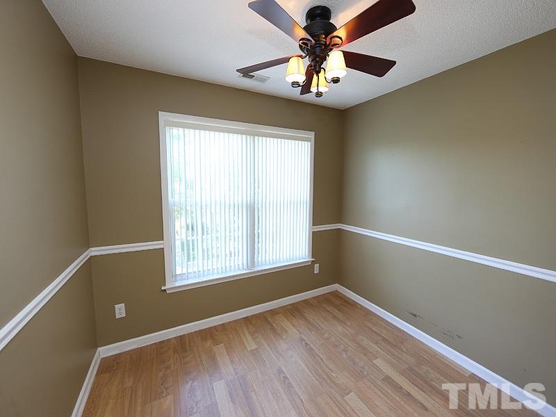4405 Moss Spring Drive Raleigh, NC 27616 - Photo 9 of 12 a view of an empty room with window and wooden floor