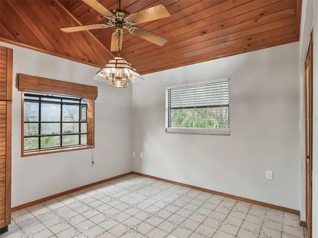 a view of a refrigerator in kitchen and a window