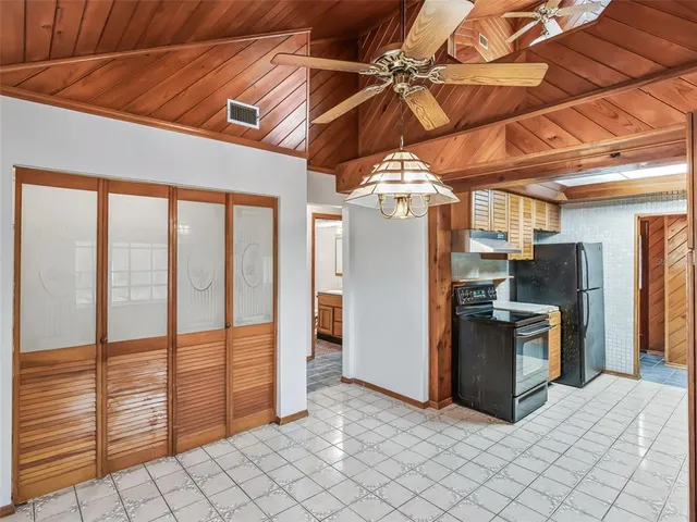 an empty room with a window and a ceiling fan