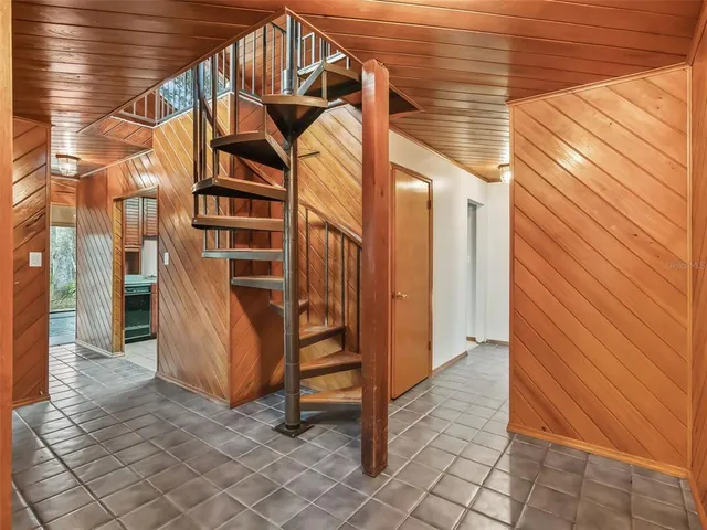a view of a house with backyard and wooden fence