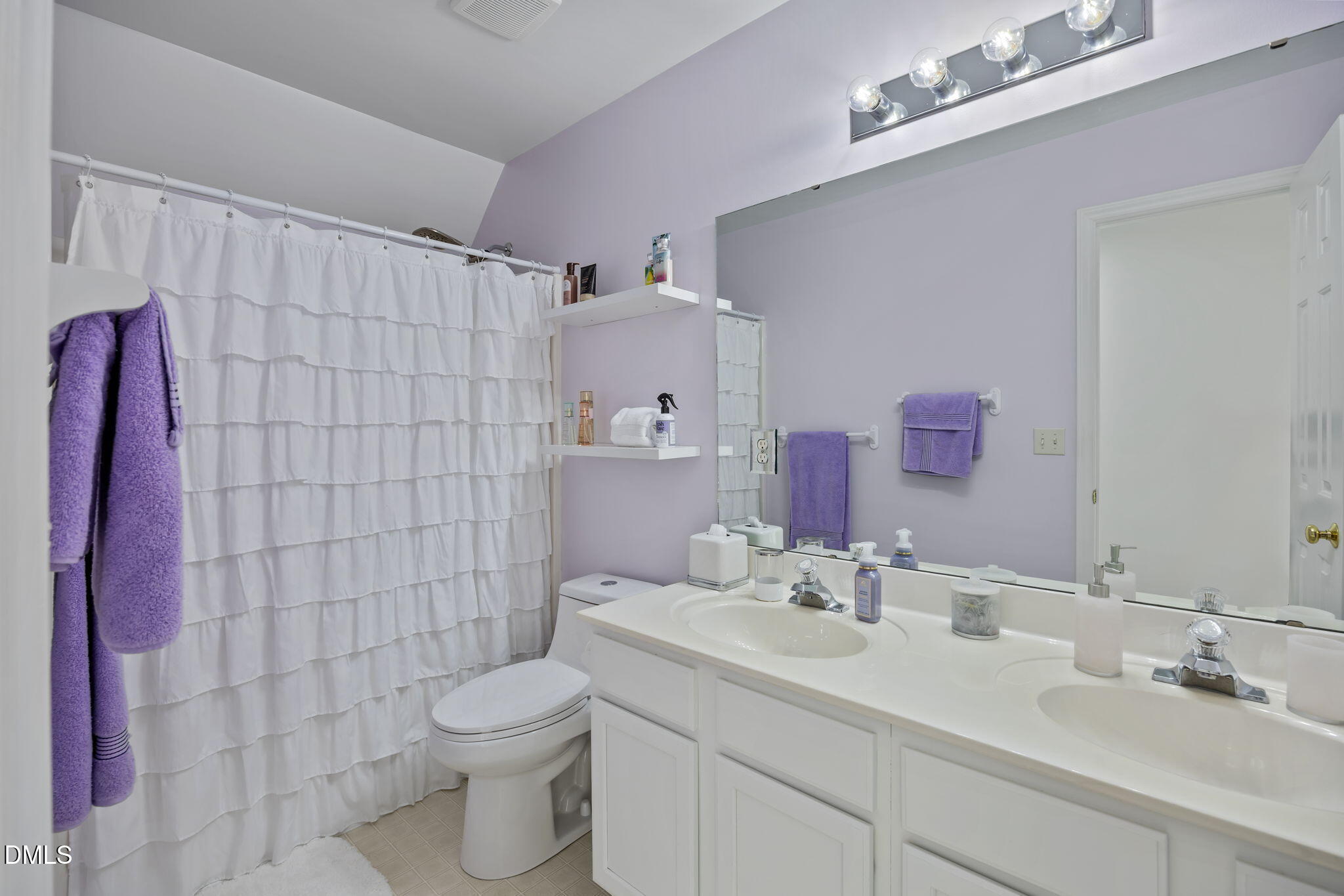 7 Bethany Place Durham, NC 27712 - Photo 23 of 33 a bathroom with a sink a toilet and shower curtain