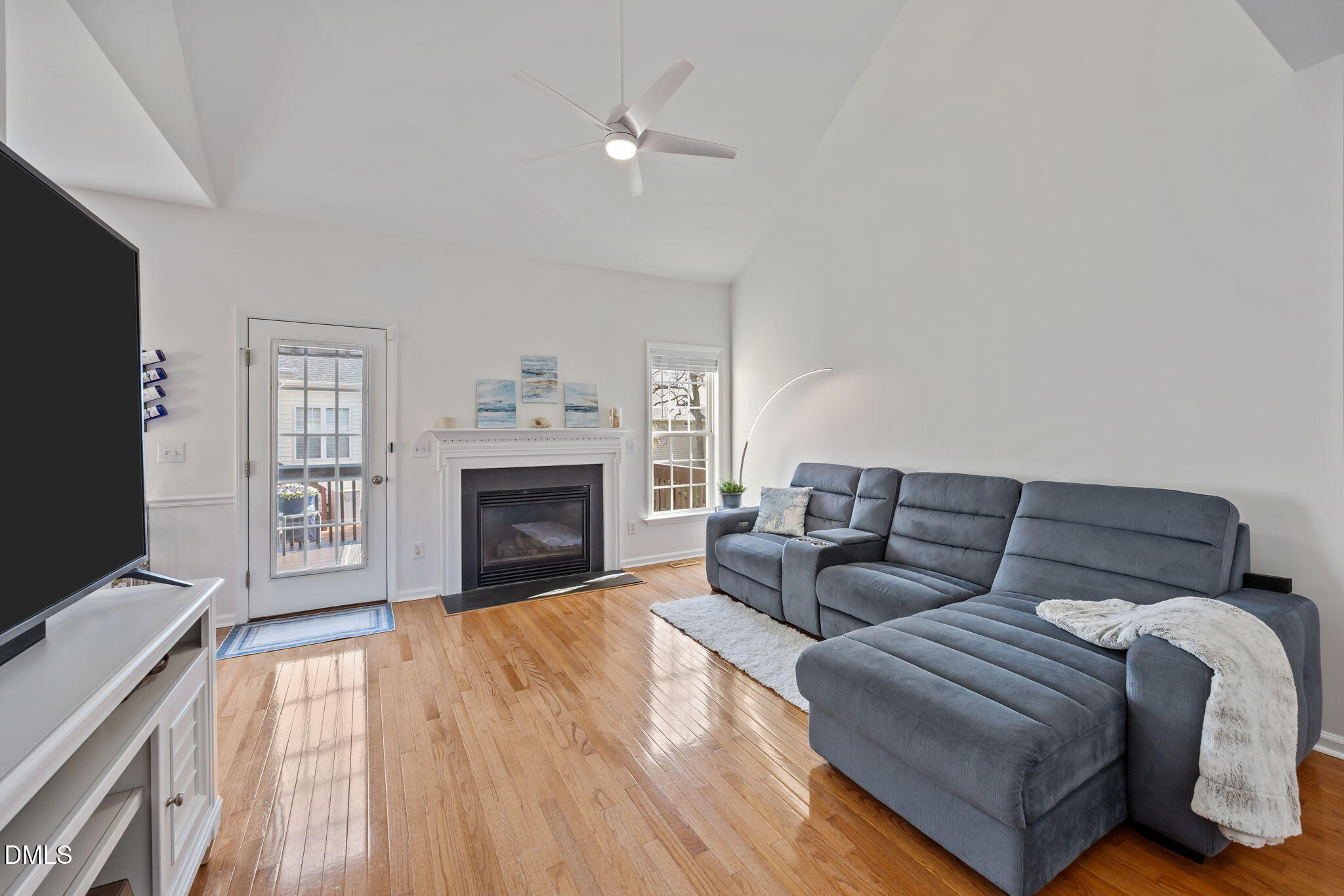7 Bethany Place Durham, NC 27712 - Photo 6 of 33 a living room with furniture a fireplace and a flat screen tv