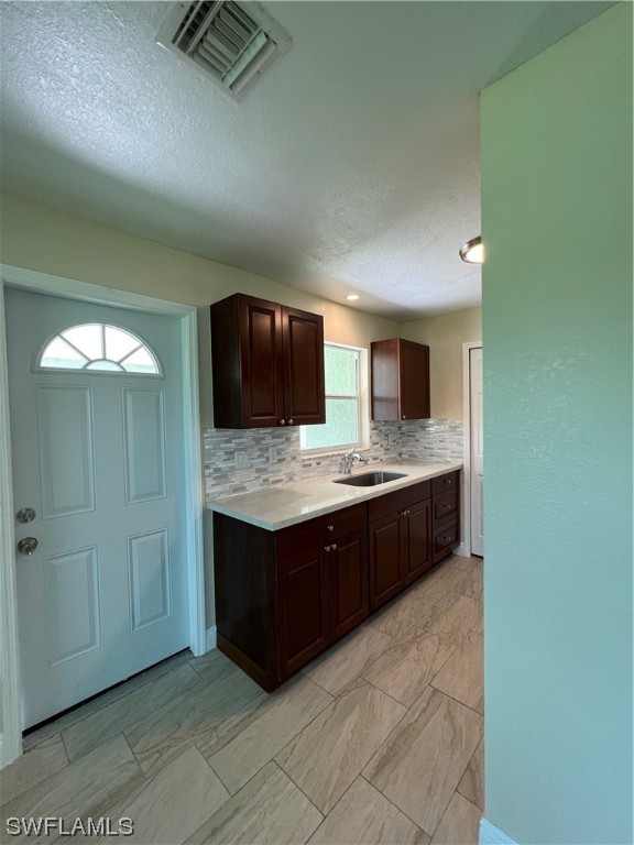 513 Wyoming Road Lehigh Acres, FL 33936 - Photo 8 of 30 a kitchen with stainless steel appliances granite countertop a sink and a stove