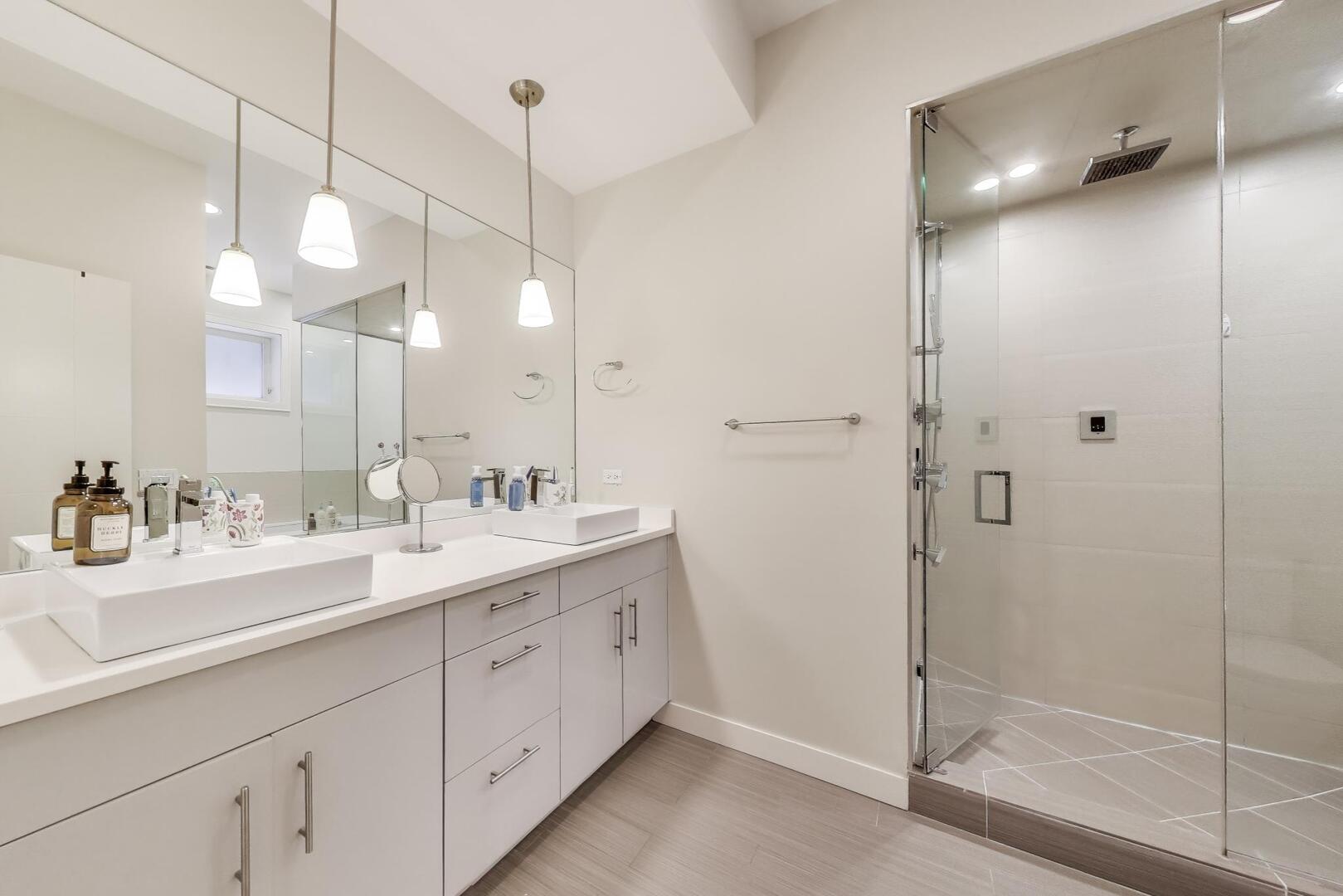 1832 West Rice Street, Unit 1N Chicago, IL 60622 - Photo 15 of 28 a bathroom with a double vanity sink a large mirror and shower