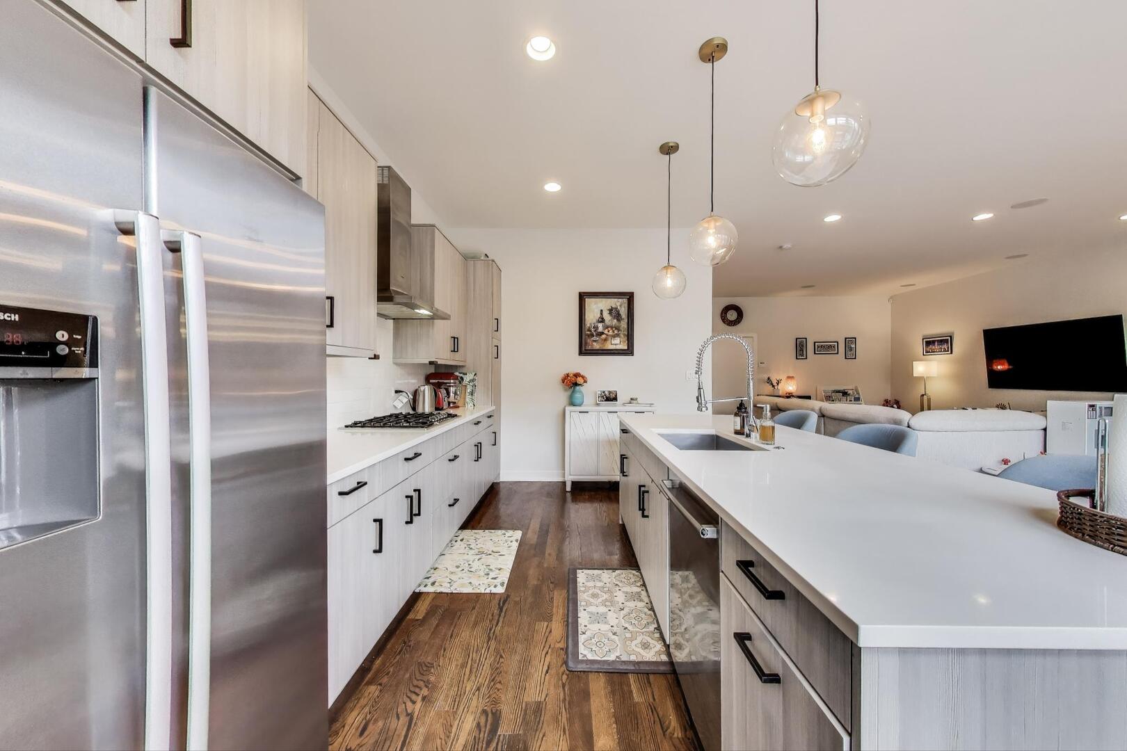 1832 West Rice Street, Unit 1N Chicago, IL 60622 - Photo 10 of 28 a kitchen with white cabinets and stainless steel appliances