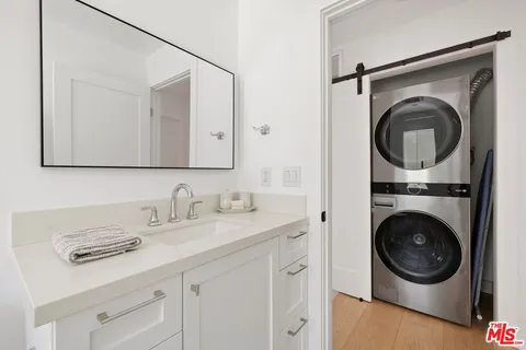 a utility room with sink dryer and washer