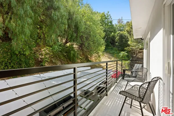 a view of a balcony with chairs
