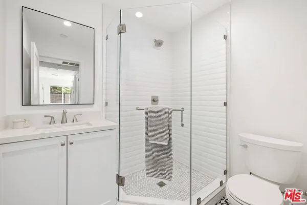 a bathroom with a shower a toilet and sink