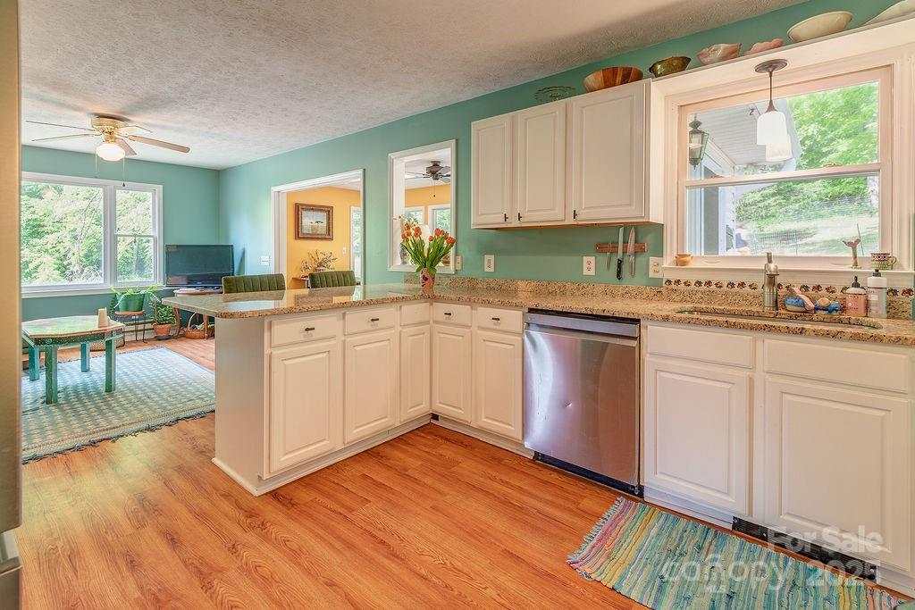 124 Beaverdam Loop Road Candler, NC 28715 - Photo 11 of 31 a kitchen with a sink window and cabinets