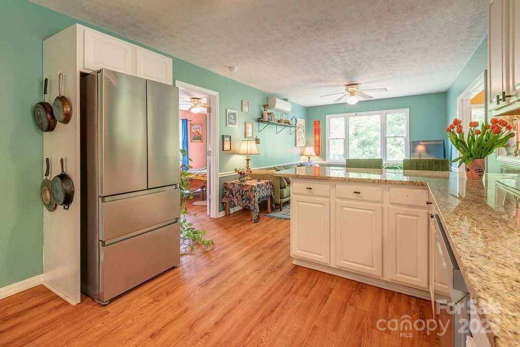 124 Beaverdam Loop Road Candler, NC 28715 - Photo 13 of 31 a kitchen with a refrigerator and a sink