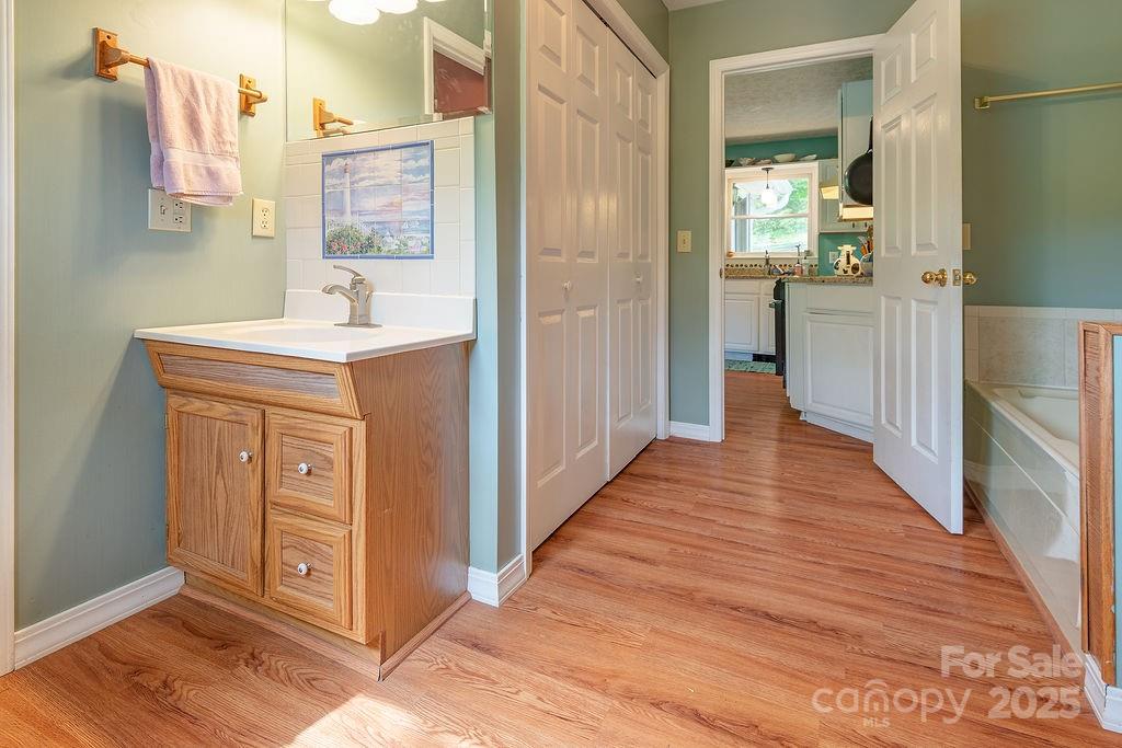 124 Beaverdam Loop Road Candler, NC 28715 - Photo 17 of 31 a hallway view with wooden floor and staircase