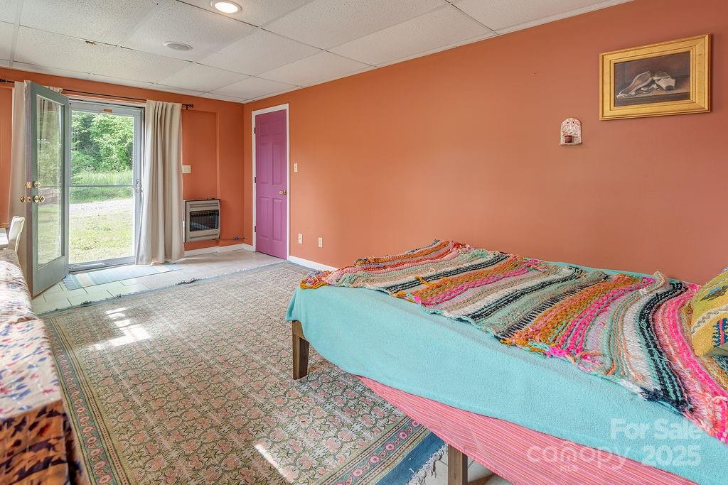 124 Beaverdam Loop Road Candler, NC 28715 - Photo 19 of 31 a bed sitting in a bedroom next to a window