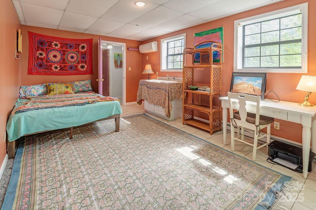124 Beaverdam Loop Road Candler, NC 28715 - Photo 20 of 31 a bedroom with furniture and a flat screen tv