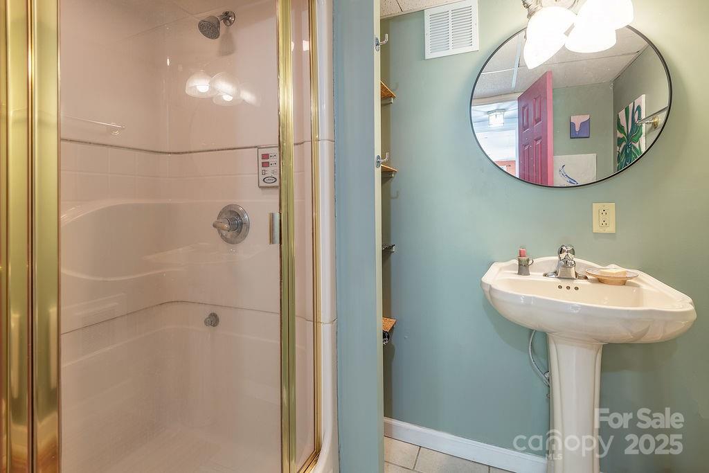 124 Beaverdam Loop Road Candler, NC 28715 - Photo 21 of 31 a bathroom with a sink and mirror