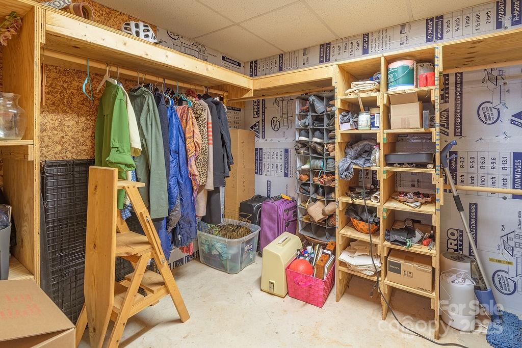 124 Beaverdam Loop Road Candler, NC 28715 - Photo 22 of 31 a view of walk in closet with clothes and shoes