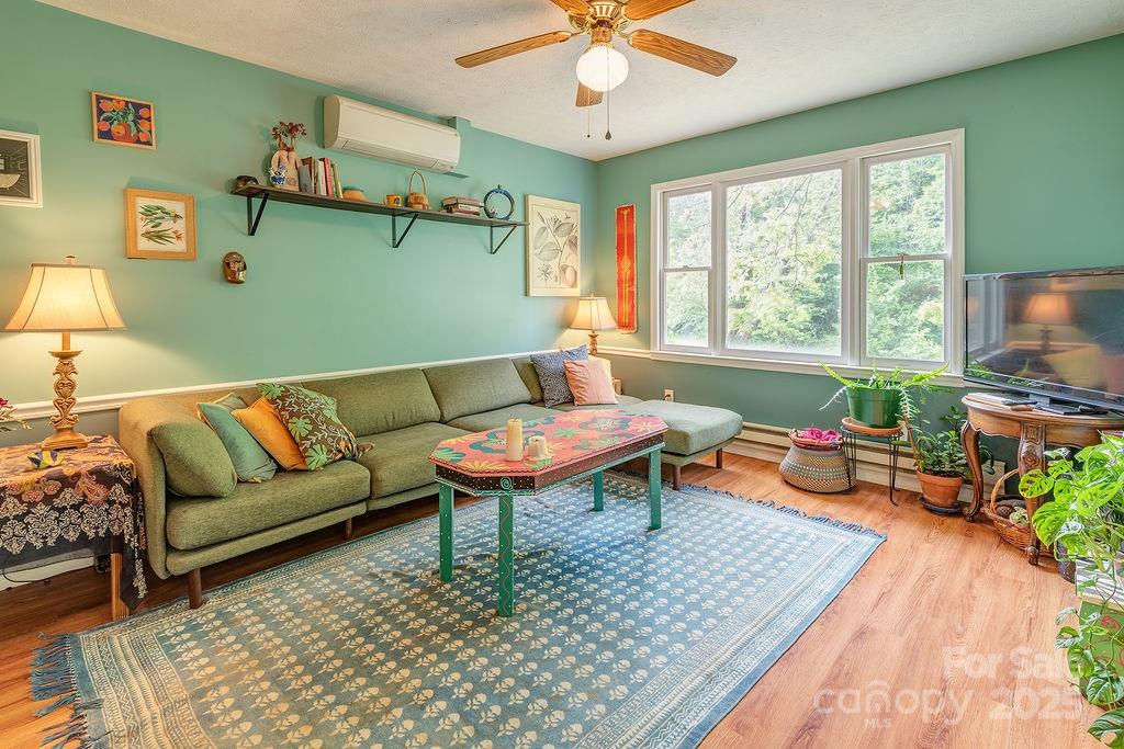 124 Beaverdam Loop Road Candler, NC 28715 - Photo 6 of 31 a living room with furniture and a wooden floor