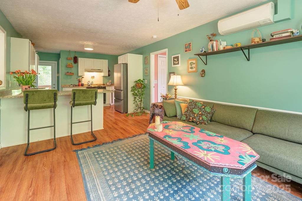 124 Beaverdam Loop Road Candler, NC 28715 - Photo 9 of 31 a living room with furniture and a wooden floor