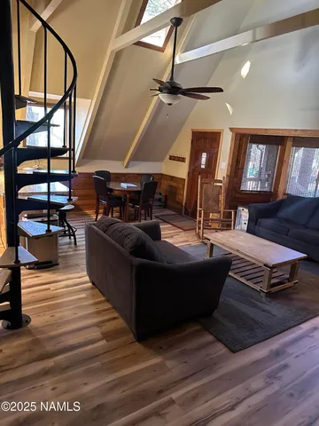 a living room with furniture and wooden floor