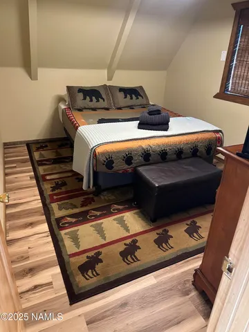 a bed sitting in a bedroom next to a window