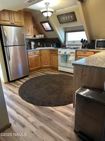 a kitchen with a sink appliances and cabinets