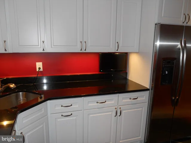 a kitchen with stainless steel appliances a stove and a microwave