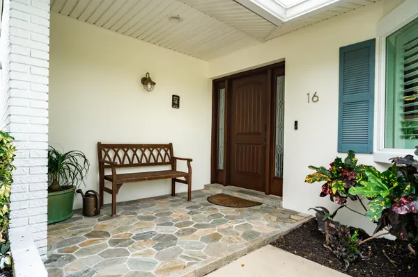 a outdoor space with a couch and potted plant