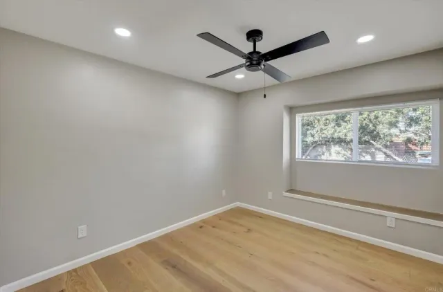 a living room with furniture wooden floor and a fireplace