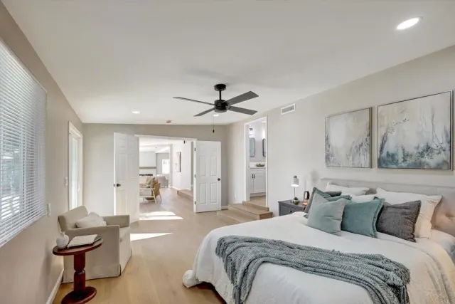 a spacious bathroom with a shower a sink and mirror