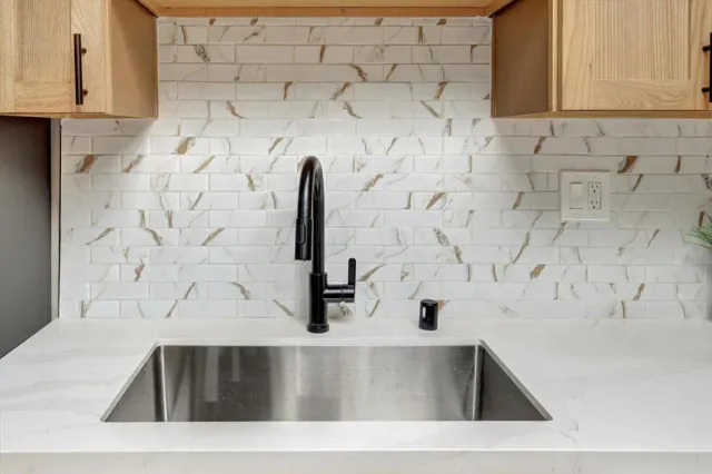 a kitchen with granite countertop a stove a microwave and cabinets