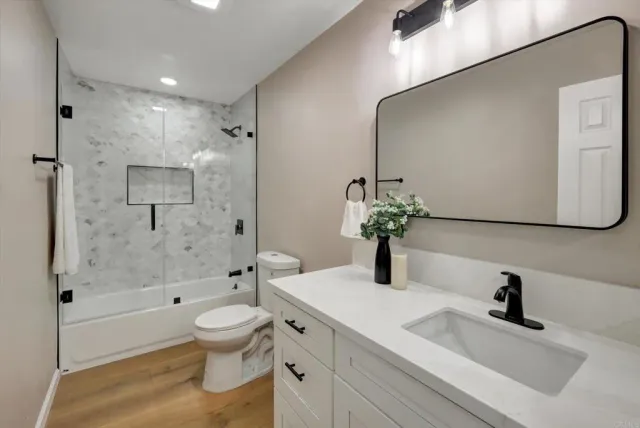 an empty room with ceiling fan and window