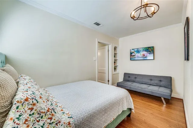 a bedroom with a bed and a chandelier