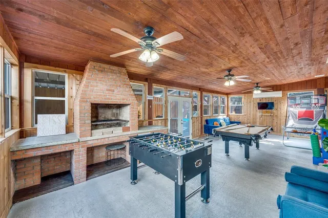 a living room with furniture a fireplace and a table