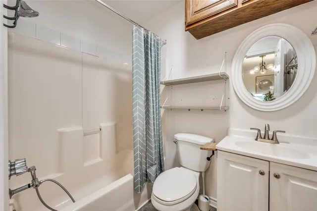 a bathroom with a toilet a sink and a mirror