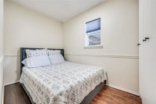 a large bed sitting in a bedroom next to a window
