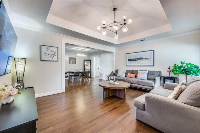 a living room with furniture and a chandelier